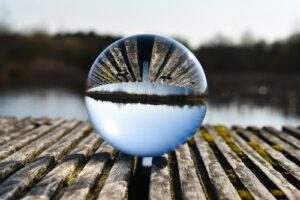 A glass ball sitting on top of a wooden table